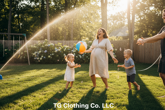 Pregnant mom laughing and playing outdoor summer games with children in backyard — TG Clothing Co. LLC family maternity lifestyle